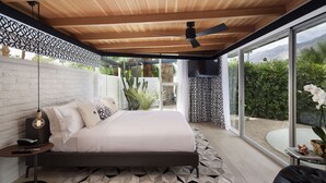 A modern bedroom with a large bed, a ceiling fan, and a view of the outdoors. - L'Horizon Resort & Spa, Hermann Bungalows (Palm Springs)