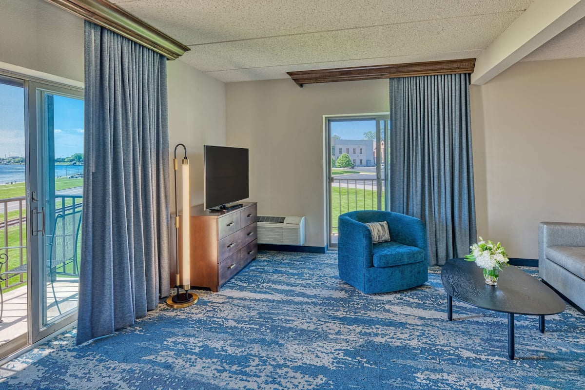 deluxe room, 1 king bed with sofa bed, balcony, river view | living area | lcd tv, mp3 dock