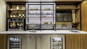 A kitchen with wine bottles, glasses, and a chalkboard menu. - New Haven Hotel (New Haven)