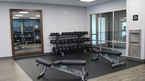 A gym with weightlifting equipment, benches, and a mirror. - Hampton Inn Glendale Milwaukee, WI (Milwaukee)