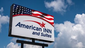 Señalización para American INN and Suites, con diseño de estrella y bandera estadounidense.
