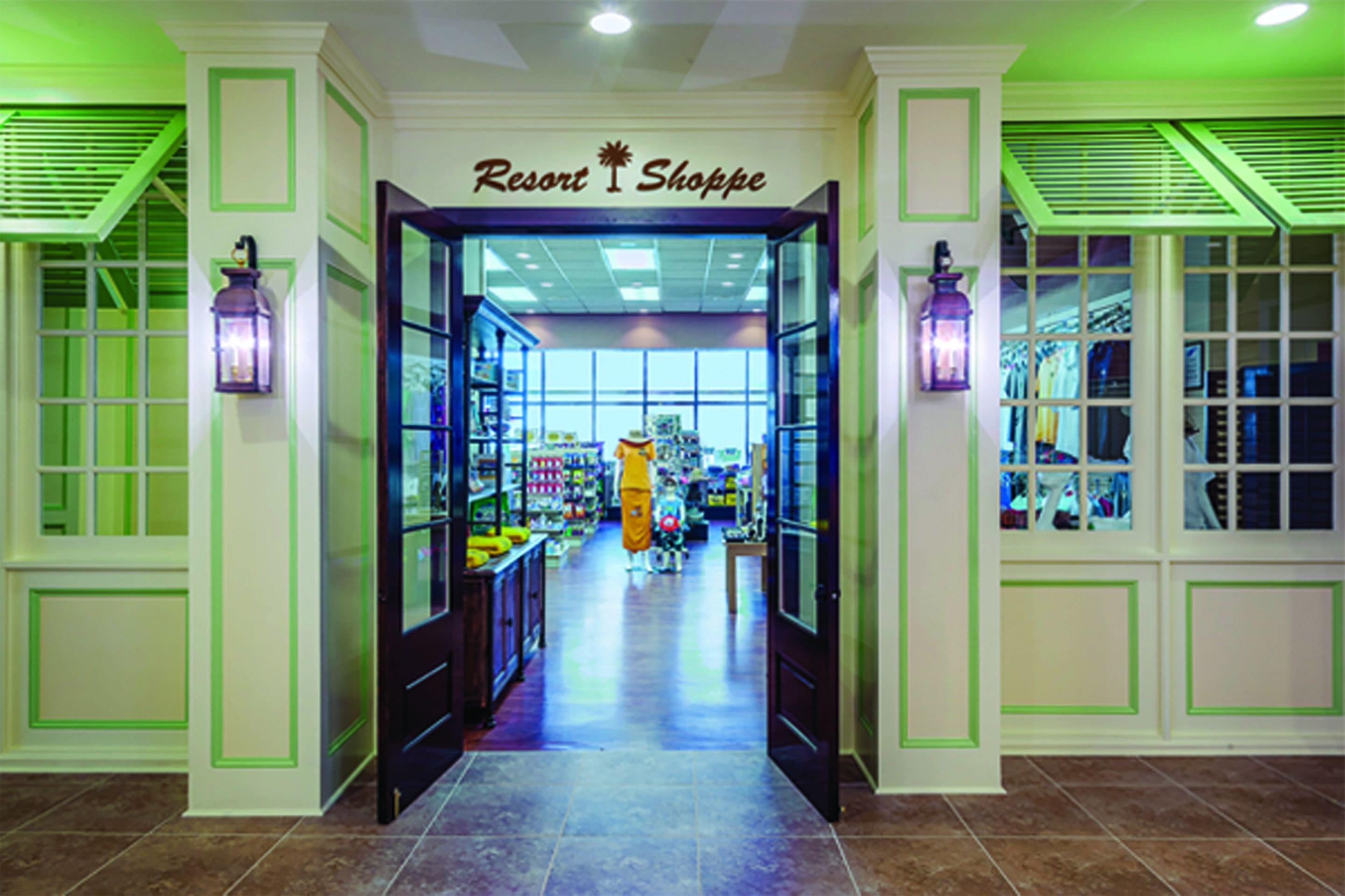 A brightly lit indoor shopping area with a sign reading "Resort Shoppe."