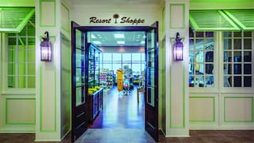 A brightly lit indoor shopping area with a sign reading "Resort Shoppe."