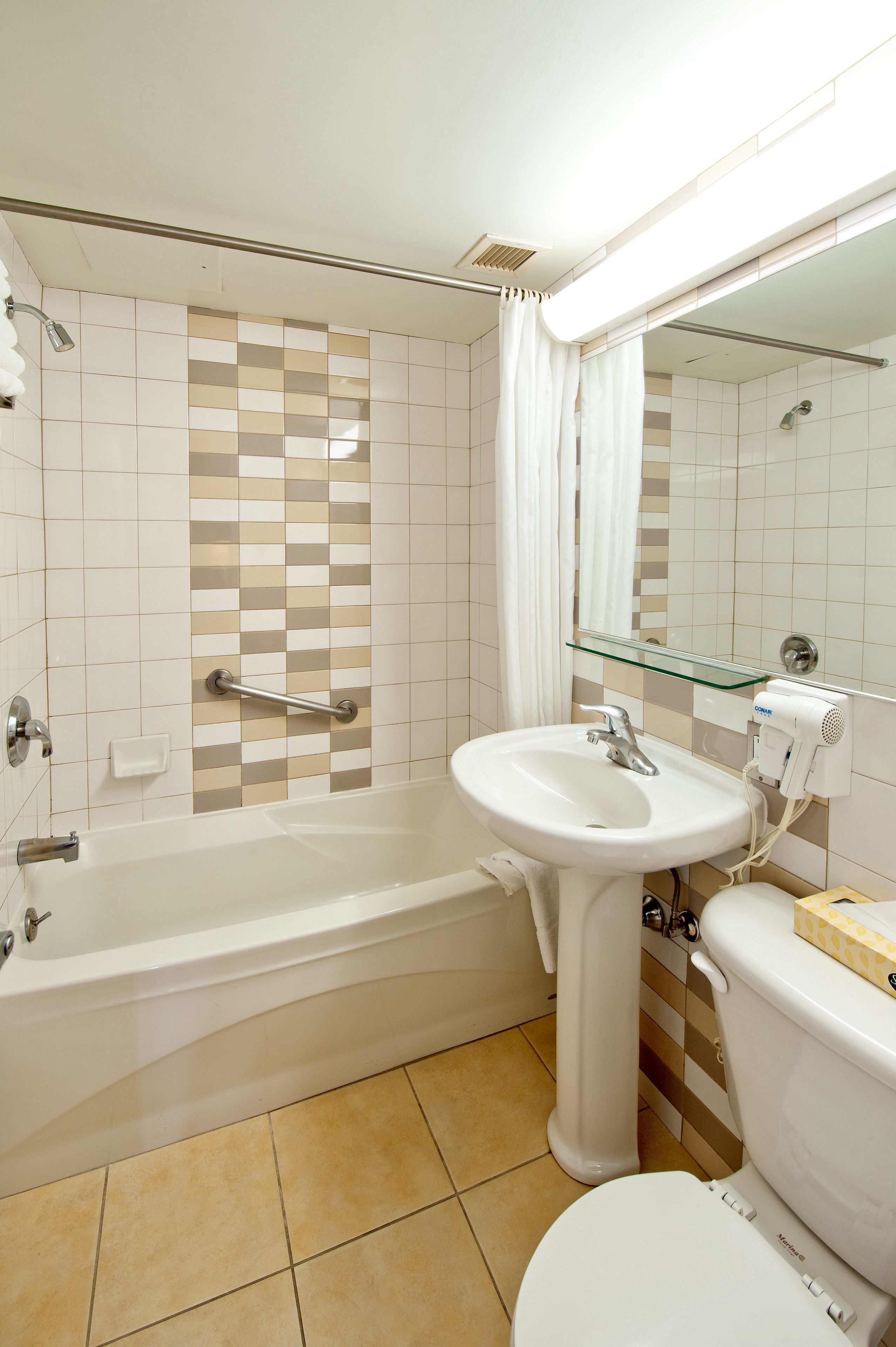 A bathroom with a bathtub, a sink, and a toilet.