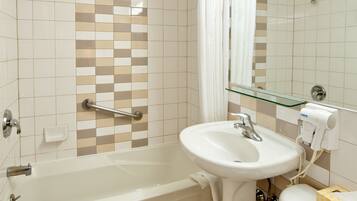 A bathroom with a bathtub, a sink, and a toilet.