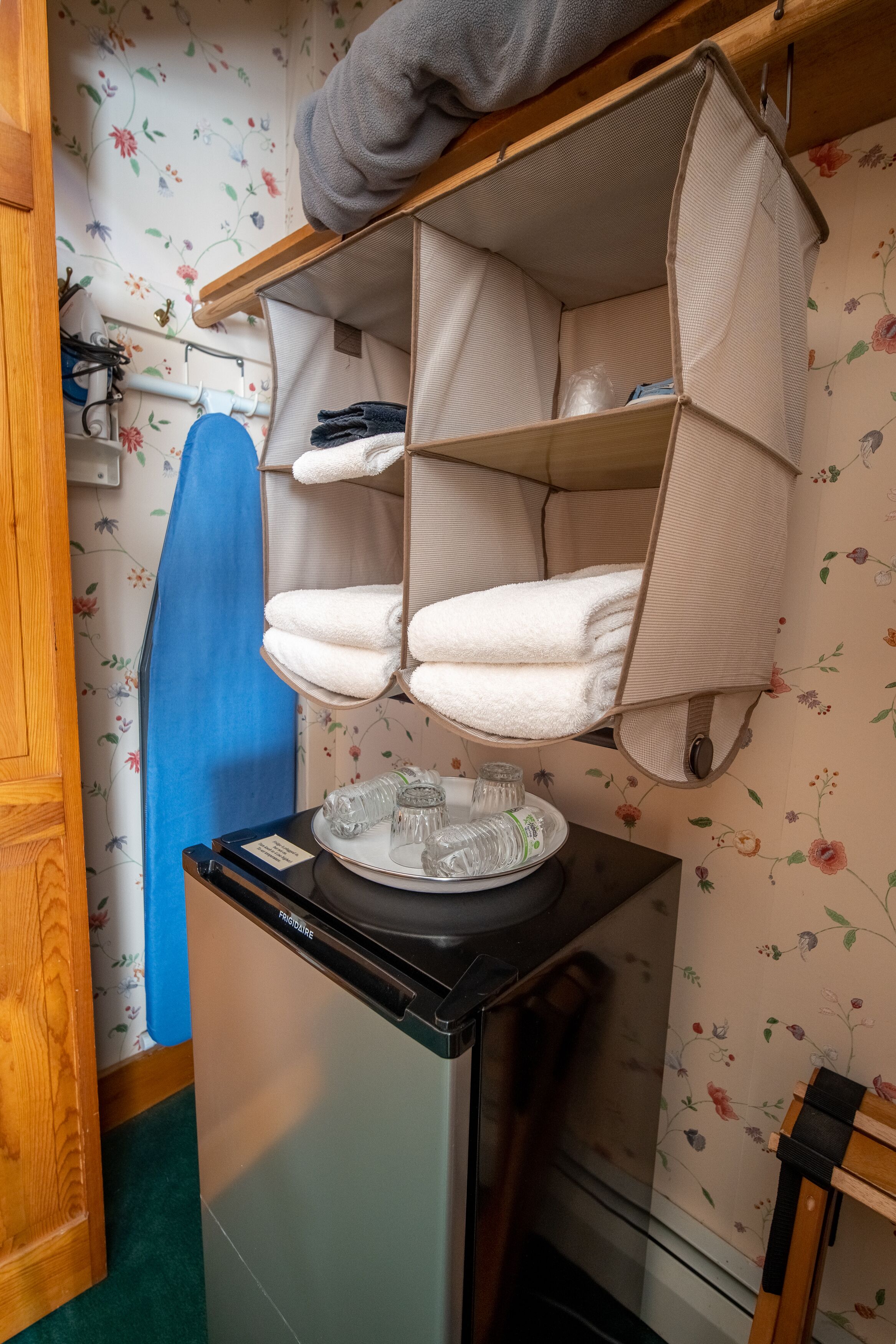 A compact kitchenette with a refrigerator, a sink, and a small countertop.