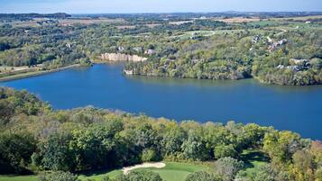 A large lake surrounded by dense forest and residential areas.