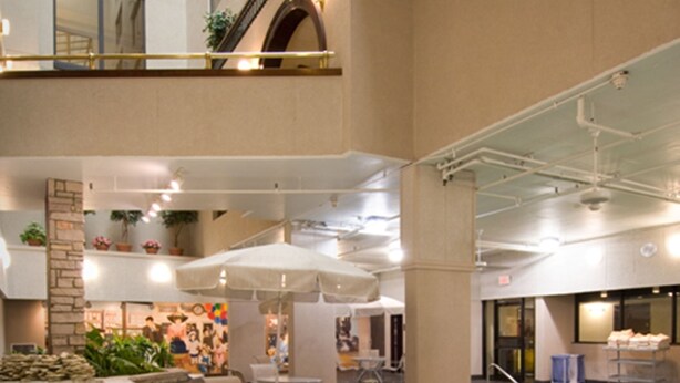 An indoor pool area with a hot tub, seating, and a stone wall. - Drury Plaza Hotel St. Louis Union Station (St. Louis)