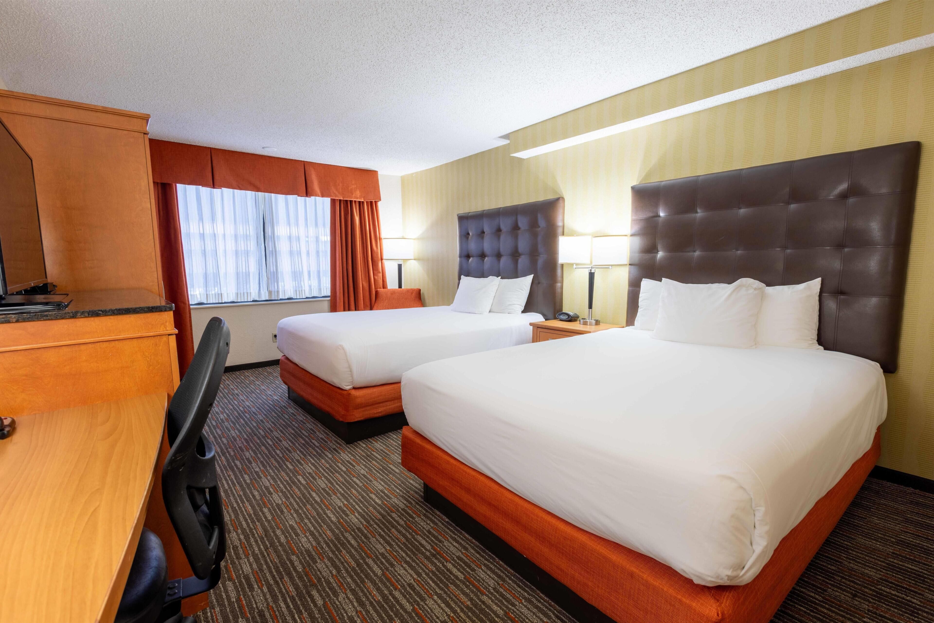 Room, 2 Queen Beds | Desk, blackout drapes, iron/ironing board, free cribs/infant beds