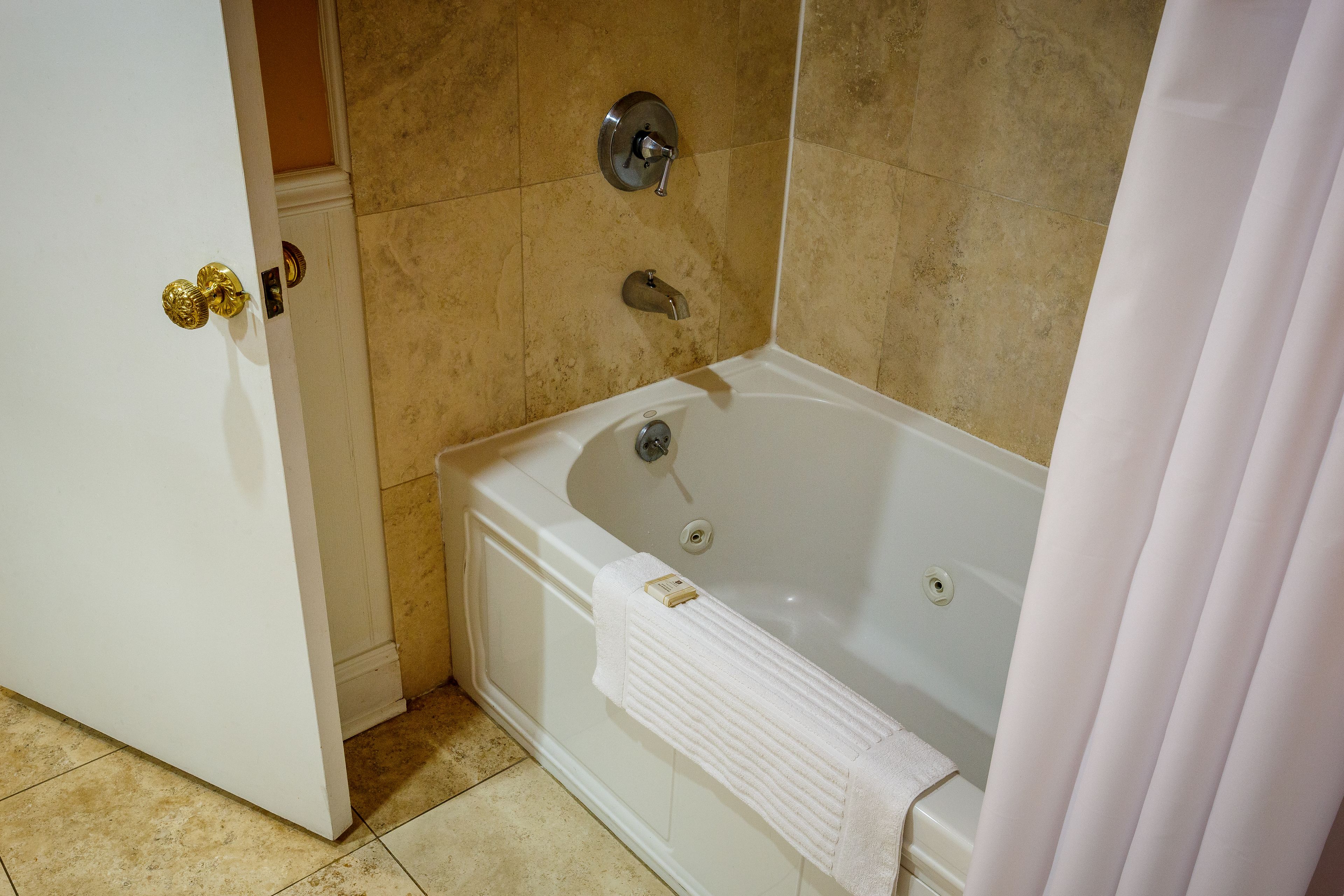 A bathroom with a bathtub, a shower, and a toilet.