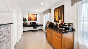 A modern hotel lobby with a reception desk, a seating area, and artwork on the walls. - Quality Inn Luray (Luray)