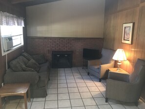 Standard Cabin, 2 Queen Beds | Living room | Flat-screen TV, fireplace, table tennis