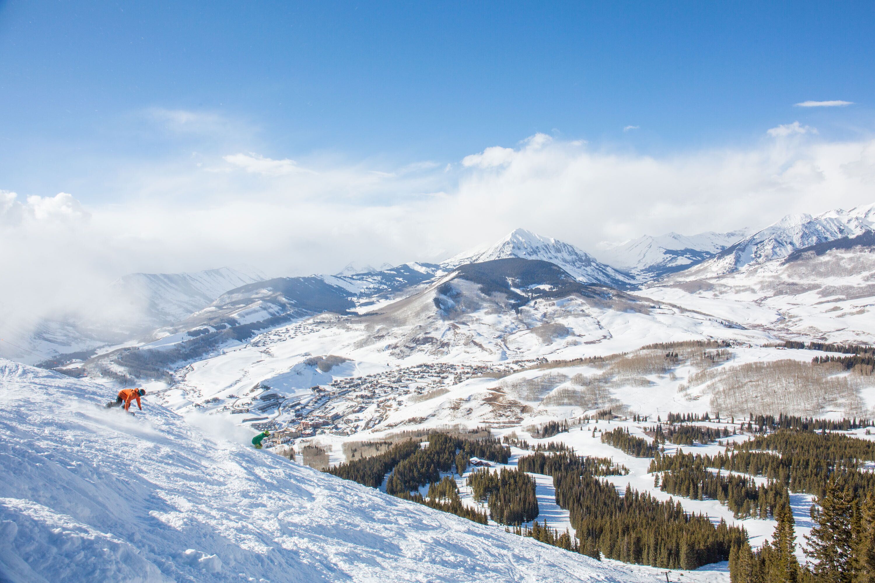 A snow-covered mountain landscape with a town nestled in the valley.
