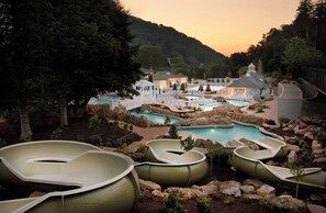 A resort with multiple swimming pools, a gazebo, and a water slide. - The Omni Homestead Resort & Spa (Hot Springs)
