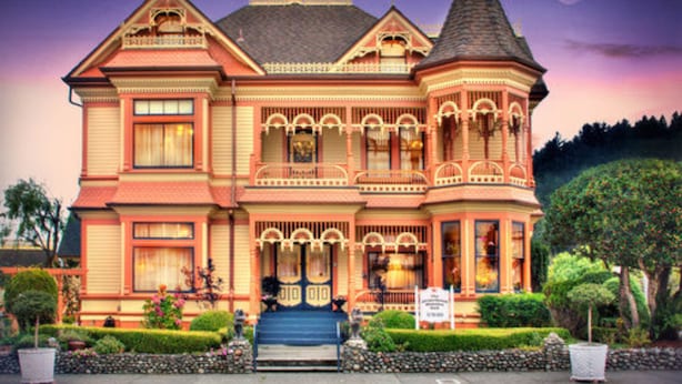 A Victorian-style house with a prominent tower, a front porch, and a well-maintained garden. - Gingerbread Mansion Inn (Ferndale)
