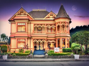 A Victorian-style house with a prominent tower, a front porch, and a well-maintained garden. - Gingerbread Mansion Inn (Ferndale)