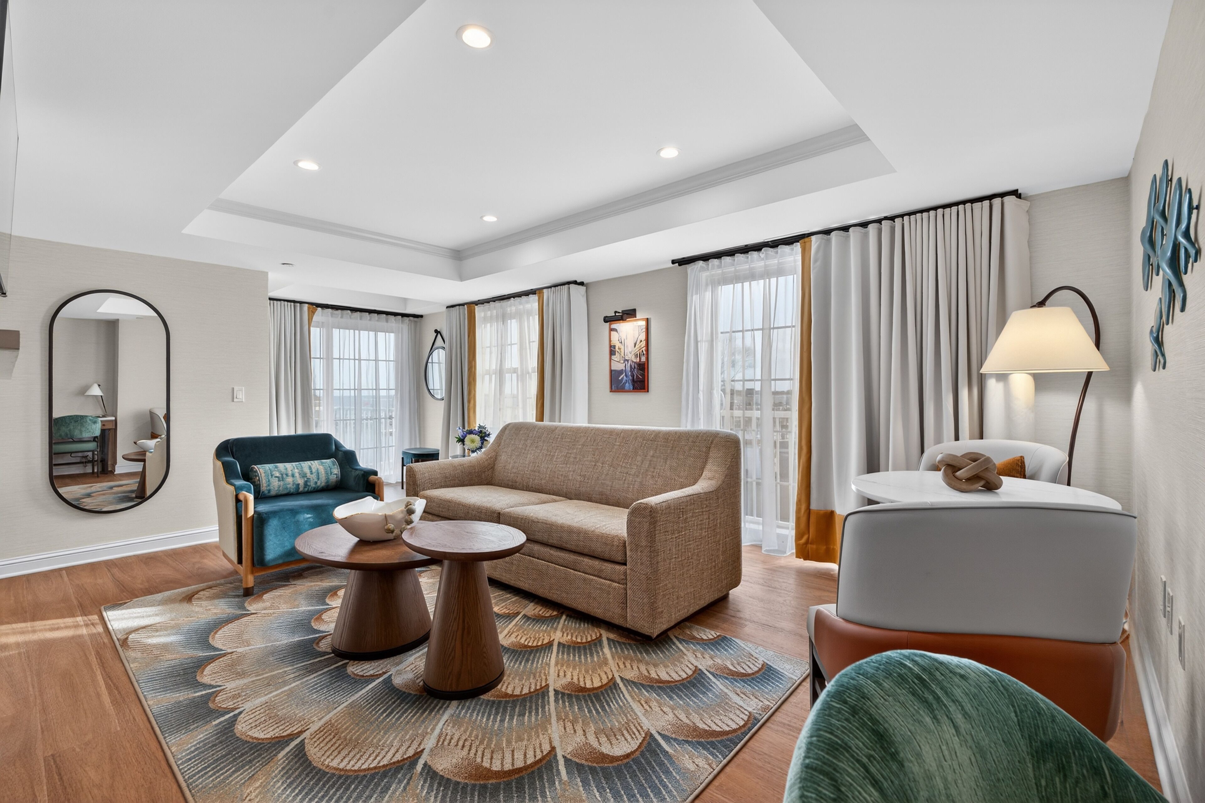A modern living room with a sofa, round coffee table, and a small side table.