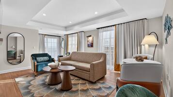 A modern living room with a sofa, round coffee table, and a small side table.