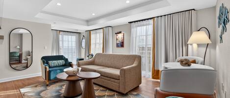 A modern living room with a sofa, round coffee table, and a small side table.