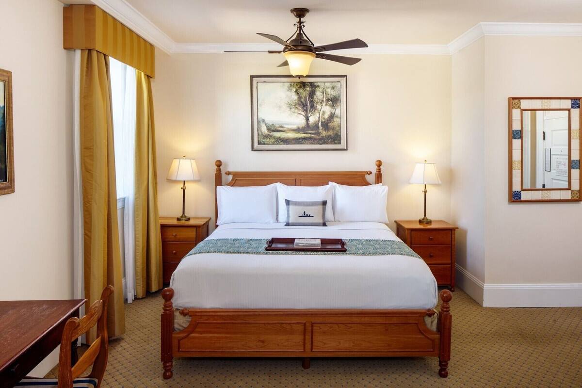Premium bedding, desk, laptop workspace, blackout drapes
