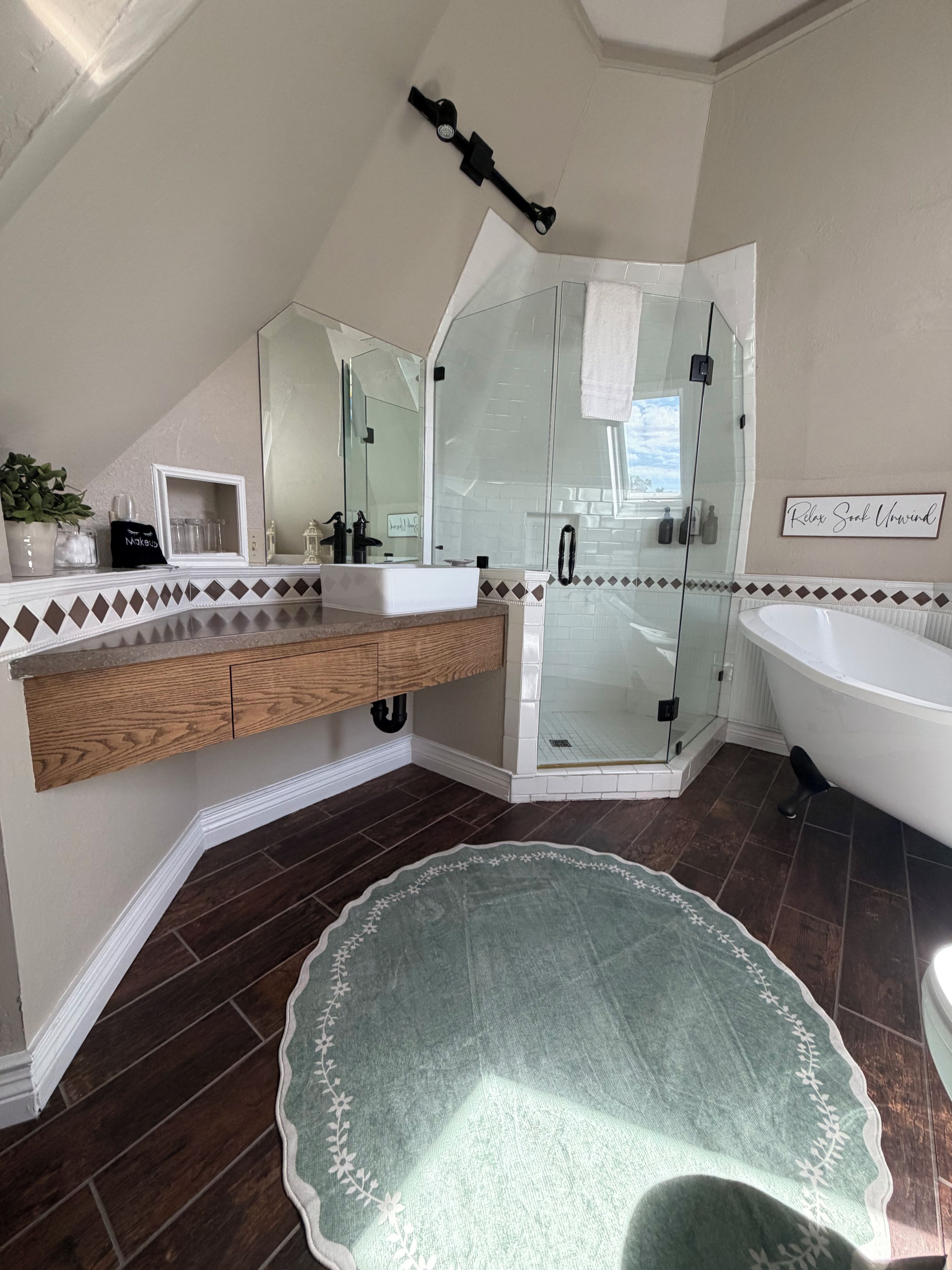 A modern bathroom with a freestanding bathtub, a glass-enclosed shower, and a vanity with a mirror.
