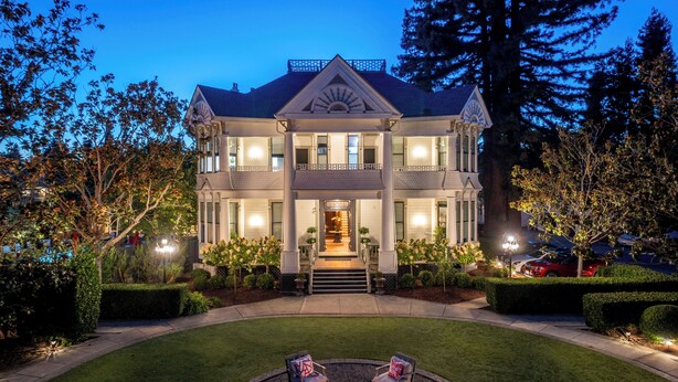 A large, two-story house with a well-maintained lawn and a fire pit in the front yard. - White House Napa (Napa)