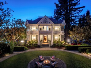 A large, two-story house with a well-maintained lawn and a fire pit in the front yard. - White House Napa - Adults Only (Napa)