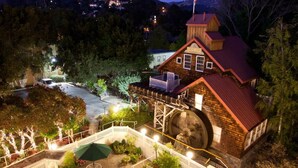 A hotel with a large pool, outdoor seating, and a mountain backdrop. - Apple Farm (San Luis Obispo)