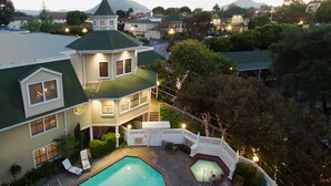 A large house with a swimming pool, a covered patio, and a view of a mountain. - Apple Farm (San Luis Obispo)