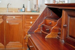A wooden cabinet with drawers and a shelf.