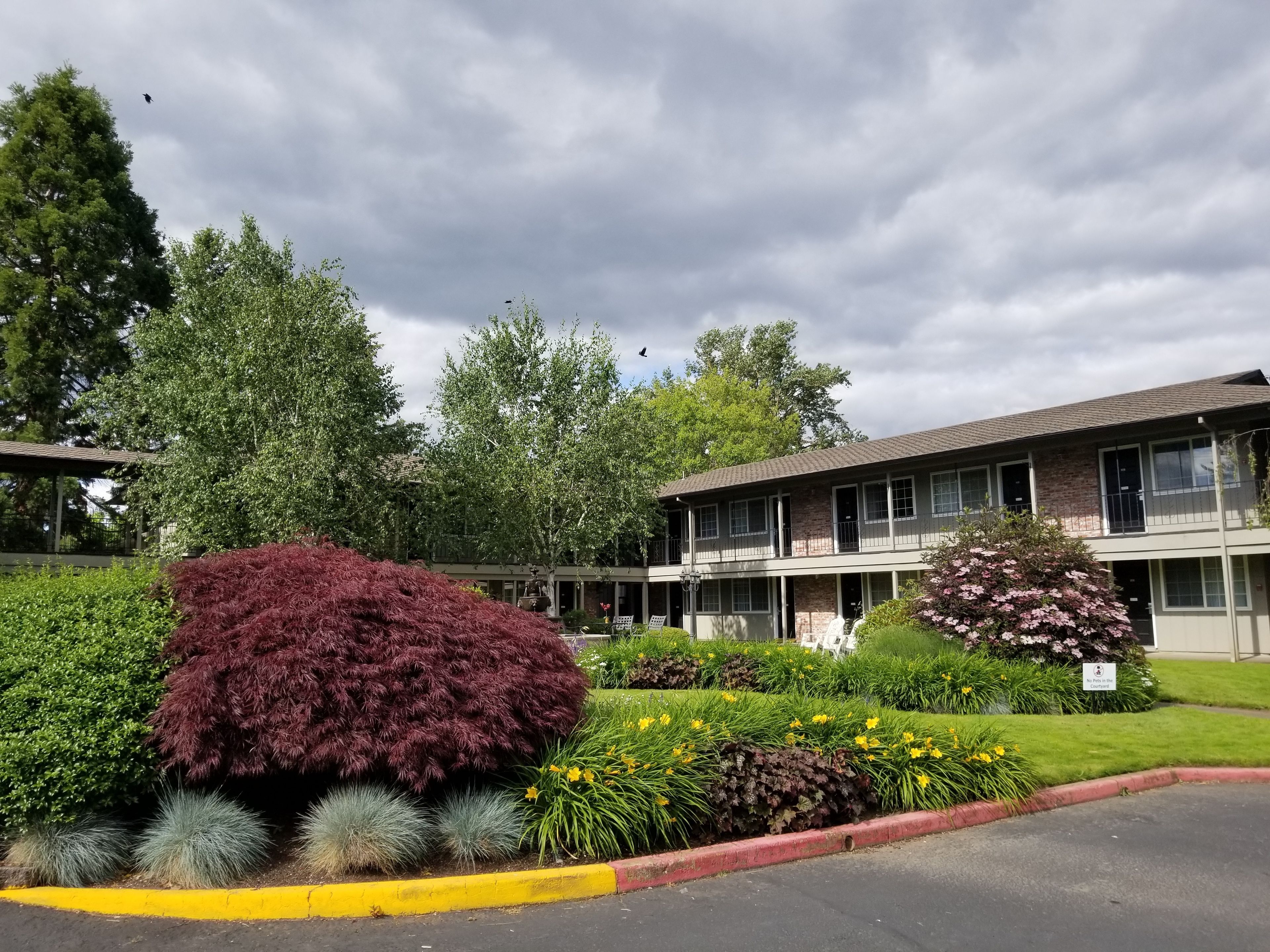 A two-story building with a flat roof and large windows.