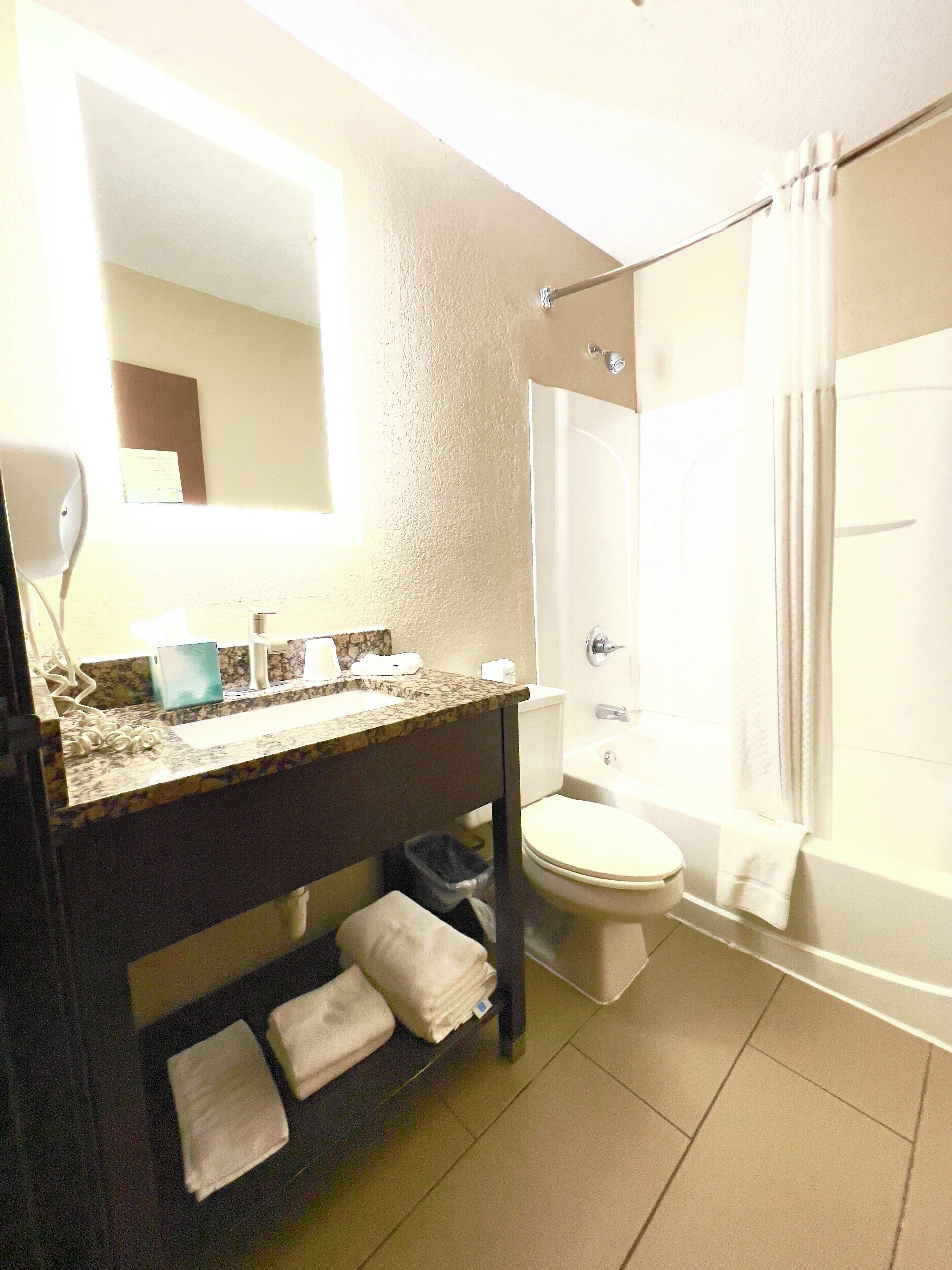 A bathroom with a sink, toilet, and bathtub.