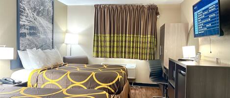 A hotel room with a bed, a desk, a chair, a TV, and a large painting on the wall.