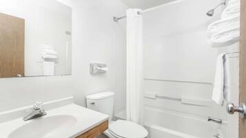 A modern bathroom with a sink, toilet, and shower.