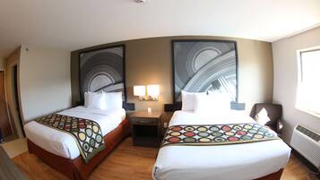 A hotel room with two beds, a nightstand with lamps, and a large abstract painting on the wall.