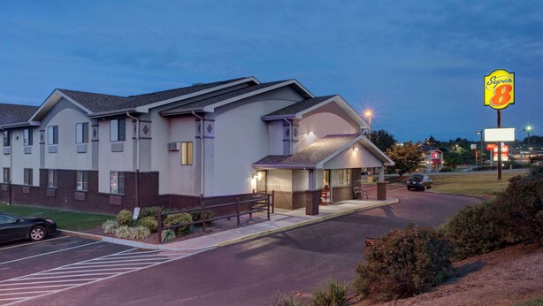 A hotel with a modern design, featuring a covered entrance and a parking lot. - Super 8 by Wyndham Christiansburg/Blacksburg Area (Christiansburg)