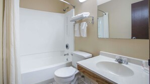 A modern bathroom with a bathtub, toilet, and sink. - Super 8 by Wyndham Christiansburg/Blacksburg Area (Christiansburg)