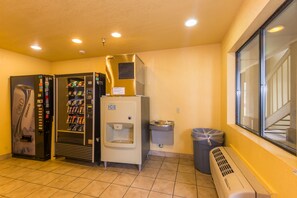 A room with a vending machine, a water dispenser, a trash bin, and an air conditioning unit. - Super 10 (Oklahoma City)