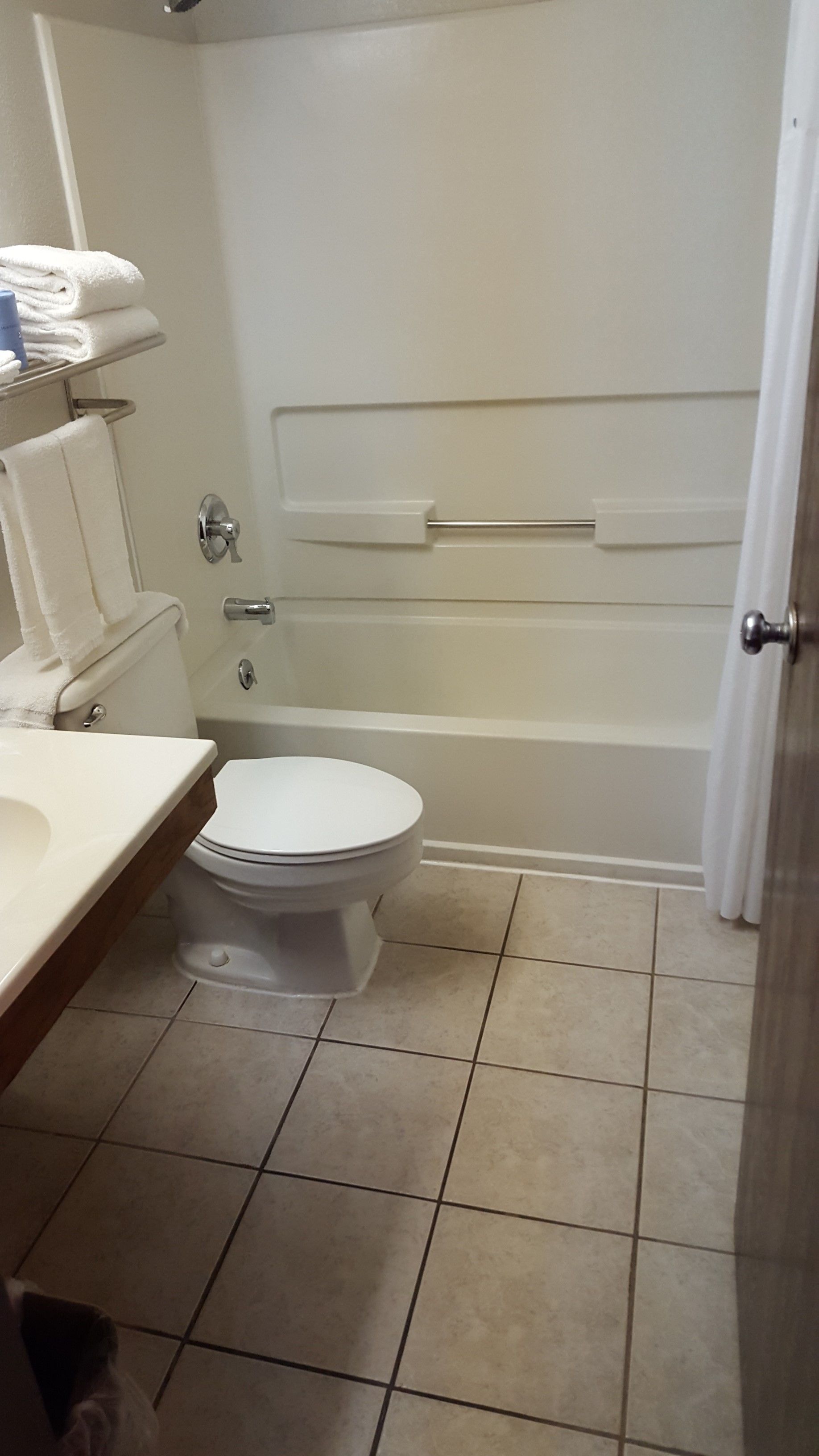 A bathroom with a toilet, sink, and bathtub.