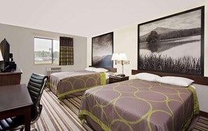 A hotel room with two beds, a desk with a chair, a lamp, and a large landscape painting on the wall. - Super 8 by Wyndham Waynesboro (Waynesboro)