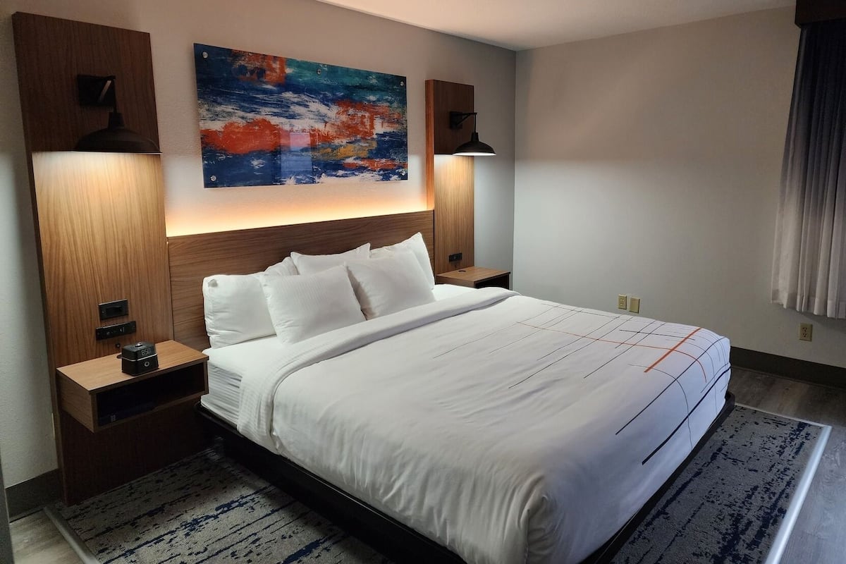 Premium bedding, desk, laptop workspace, iron/ironing board