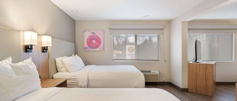 Premium bedding, pillow-top beds, desk, laptop workspace