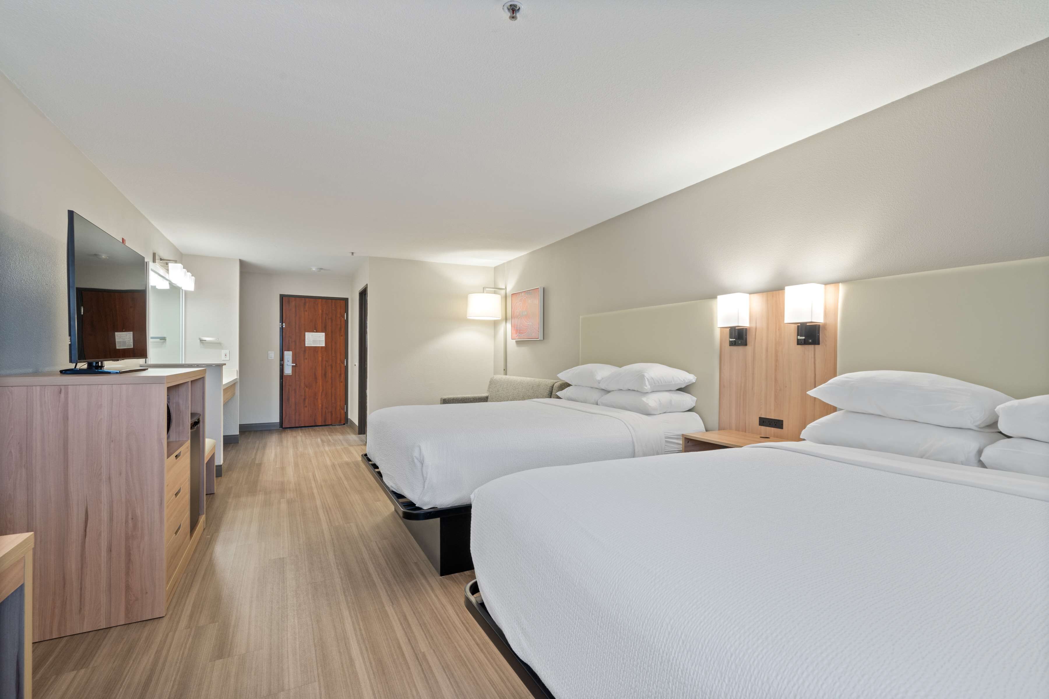 Premium bedding, pillow-top beds, desk, laptop workspace