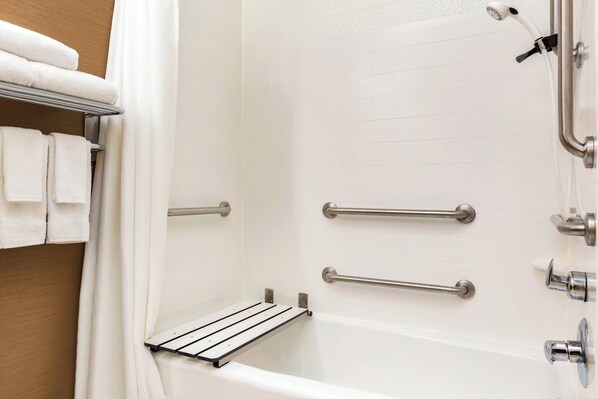 A bathroom with a white bathtub, grab bars, and a towel rack. - Fairfield Inn & Suites Toledo Maumee (Maumee)