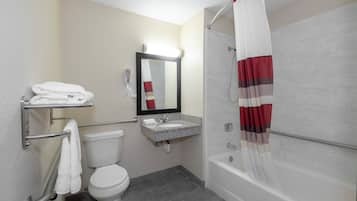 A bathroom with a toilet, sink, and shower.