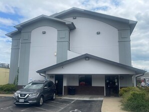 A modern building with a flat roof and two entrances. A car is parked in front. - Super 8 by Wyndham Danville VA (Danville)
