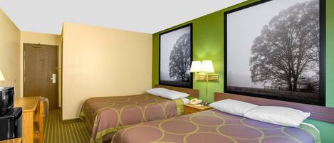 A hotel room with two beds, a desk, a chair, a lamp, and a TV.
