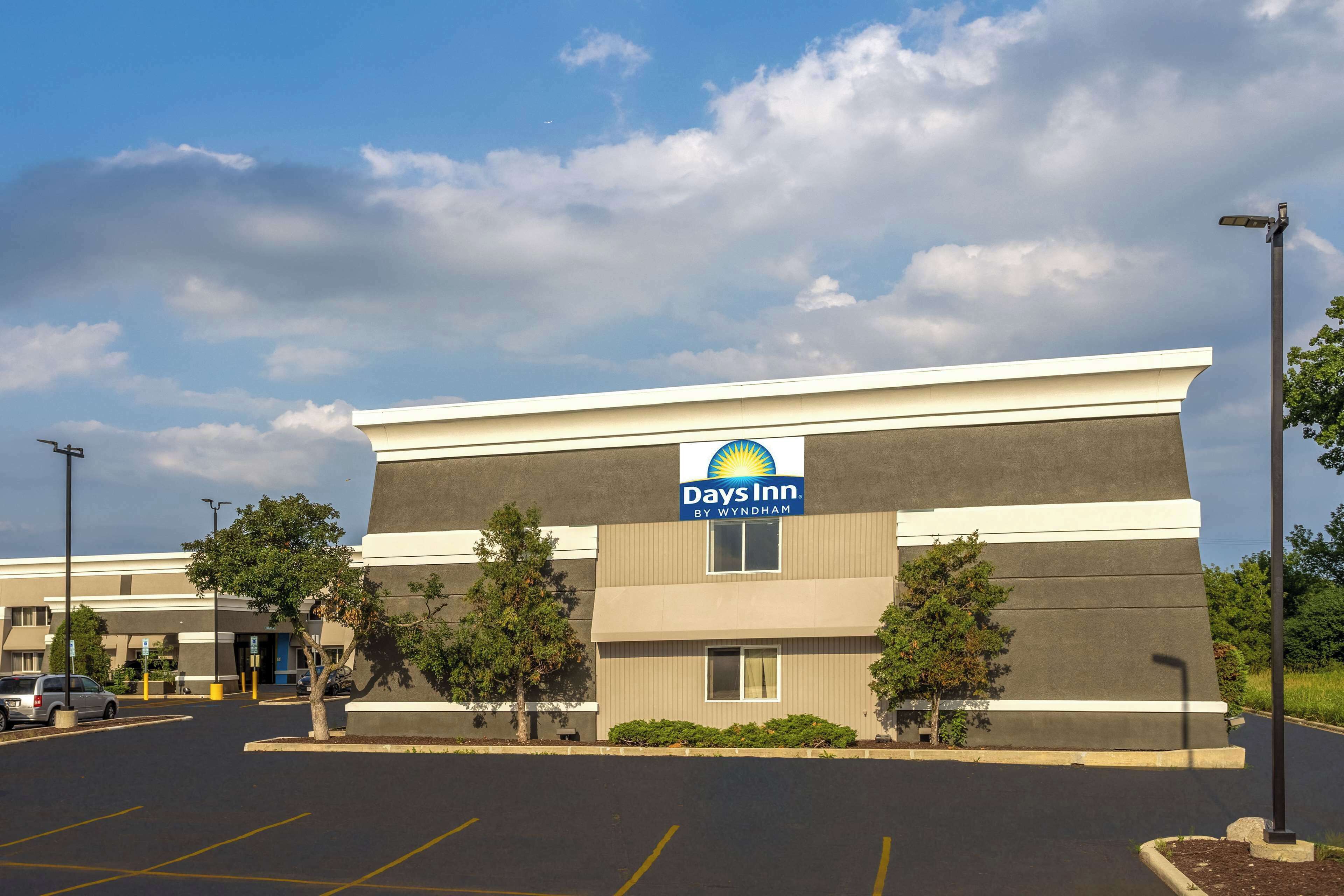 A Days Inn by Wyndham building with a parking lot in front.