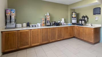 Fully equipped kitchen with a long counter, cabinets, and various appliances.