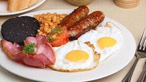 A plate of breakfast food including sausages, eggs, beans, and bacon. - Britannia Hotel Newcastle Airport (Newcastle-upon-Tyne)